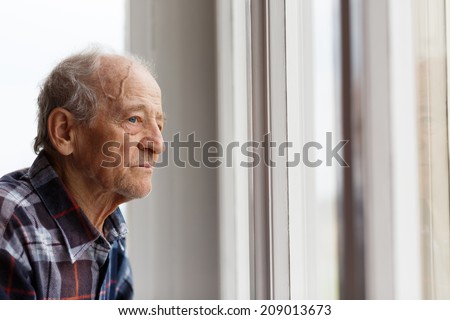 Portrait of Elderly man looking out window