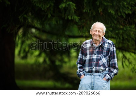 Laughing 80 year old senior elder man outside