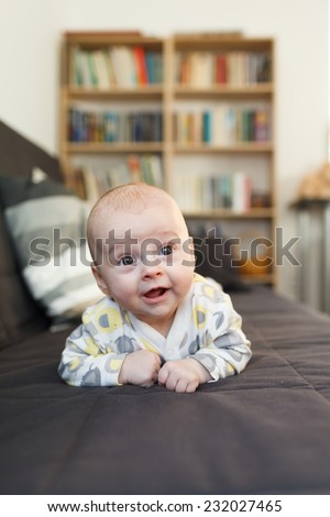 laughing baby on sofa, Beautiful smiling cute baby, expressive adorable happy child in childroom