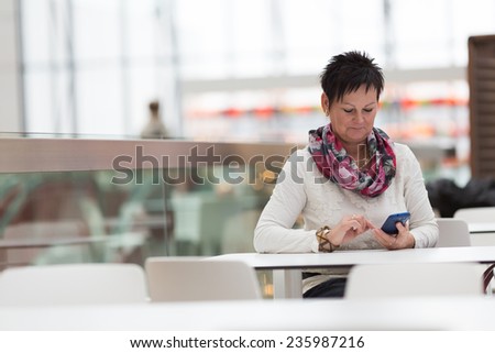 Woman sitting in cafe and calling with mobile phone. Cafe city lifestyle woman on phone. Business concept - businesswoman talking on the phone in restaurant.
