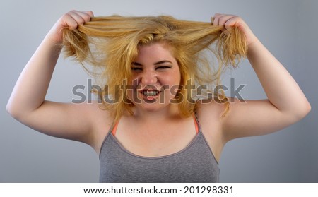 An overwhelmed girl pulls her hair
