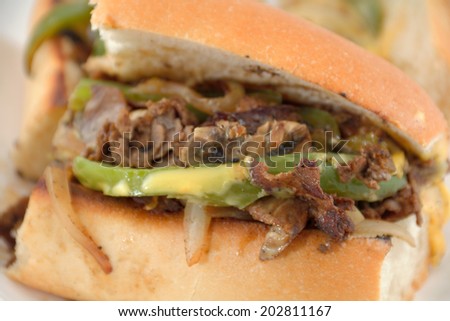 Messy philly cheese steak with mushrooms onions and peppers