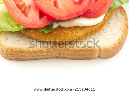 A fresh chicken patty sandwich with tomato, lettuce, and mayo on white bread
