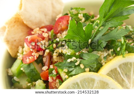 Healthy fresh vegetarian tabbouleh salad with pita chips