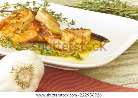 Authentic Portuguese Garlic Shrimp garnished with rosemary and thyme