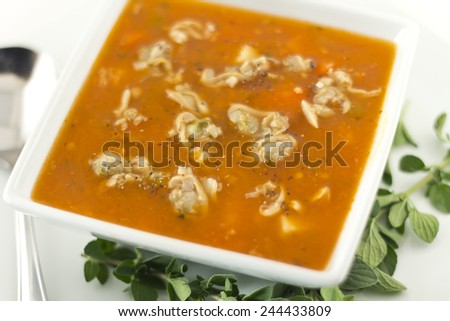Hearty Manhattan Clam Chowder soup with fresh oregano