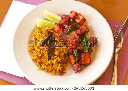 Crispy spicy Kadai Paneer Tofu with tamarind rice and lime wedges