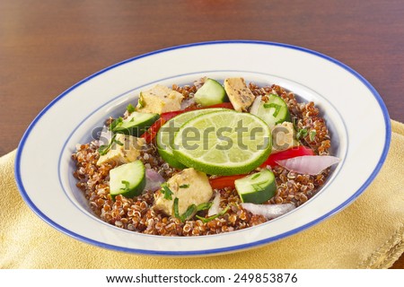 Red Quinoa Tabbouleh salad with juicy grilled chicken and cucumbers with chopped parsley