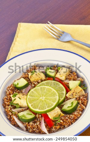 Red Quinoa Tabbouleh salad with juicy grilled chicken and cucumbers with chopped parsley