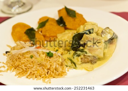 Green fish curry with side of vegetable pakora and fried rice