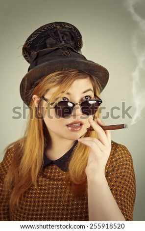 Tramp girl wears old top hat in vintage photo style