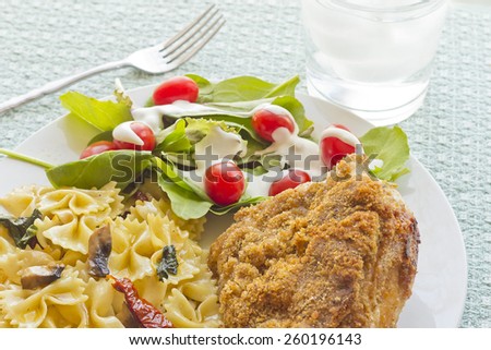 Blue cheese fried chicken with mushroom spinach and sundried tomato bowtie pasta and light salad