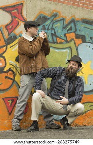 Two snazzy stylish men hang out on a street corner