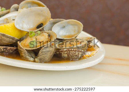 Chinese baby clams sauteed in sweet and spicy black bean sauce with lemon wedge