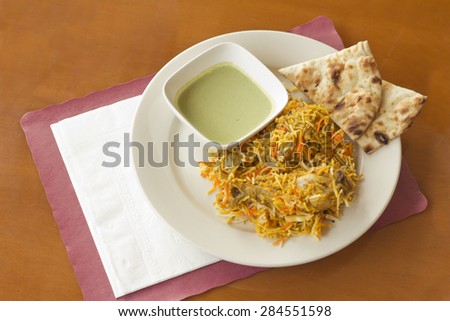Indian biryani chicken with naan and mint coriander chutney sauce
