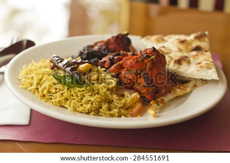 Indian tandoori chicken with fresh naan and tamarind rice