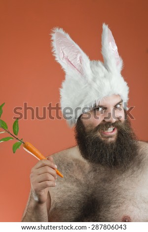 Grinning bearded fat man wears silly bunny ears