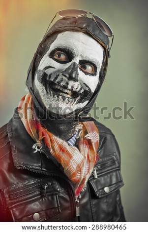 Smiling creepy aviator with skull face paint