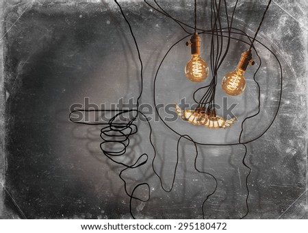 Smiling anthropomorphic face made from hanging edison light bulbs