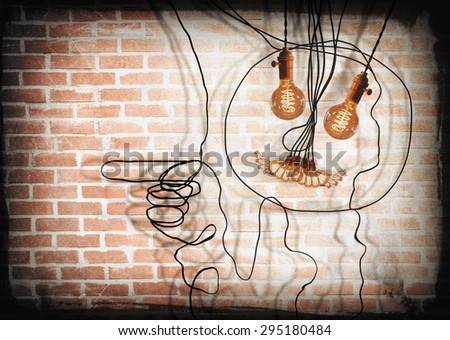 Smiling anthropomorphic face made from hanging edison light bulbs