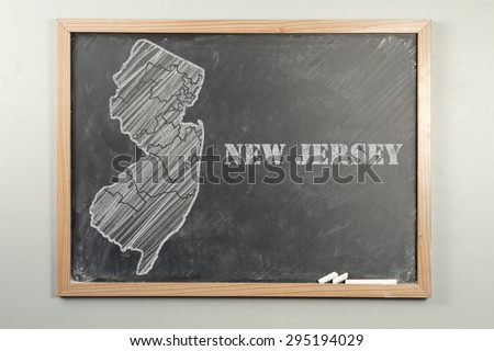 Outlined New Jersey US state on grade school chalkboard
