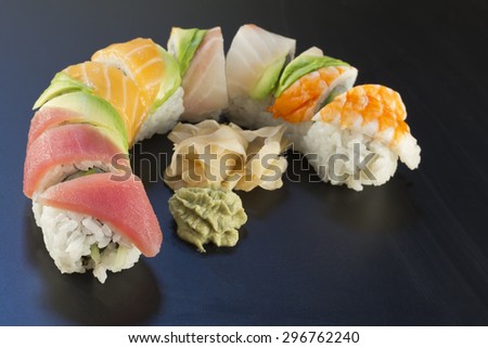 Rainbow sushi roll sliced with wasabi and fresh ginger