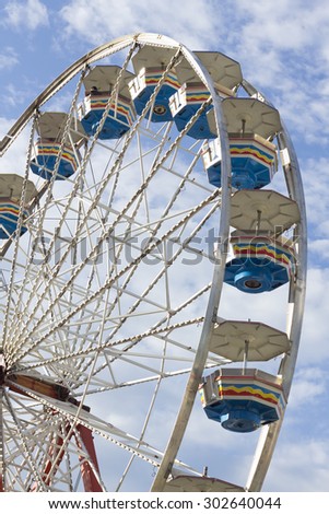 Close up summer carnival ferris wheel against blue sky