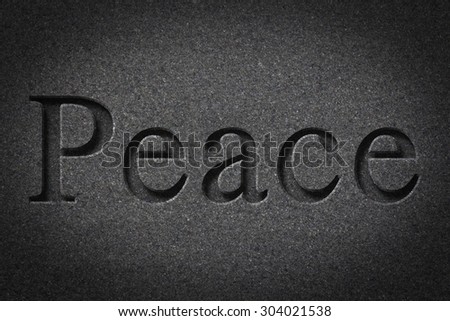 Engraving spelling the word Peace on textured old surface