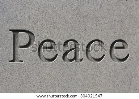 Engraving spelling the word Peace on textured old surface