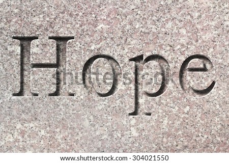 Engraving spelling the word Hope on textured old surface