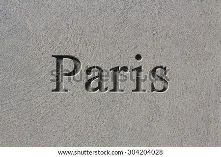 Engraving spelling the city Paris on textured old surface