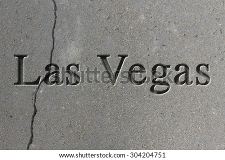 Engraving spelling the city Las Vegas on textured old surface