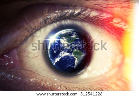 Planet earth reflects in a macro close of a mans eye, Elements of photo furnished from NASA