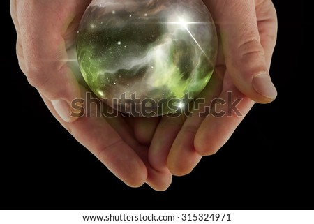 Holding the universe in fortune teller magic crystal ball