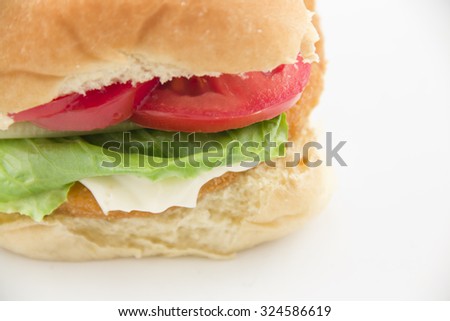 Fresh chicken patty sandwich with tomato, lettuce, and mayo on a bun