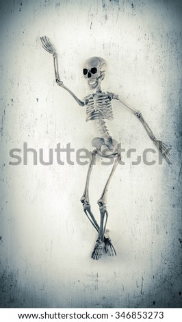 Silly dancing medical skeleton on grunge vintage background