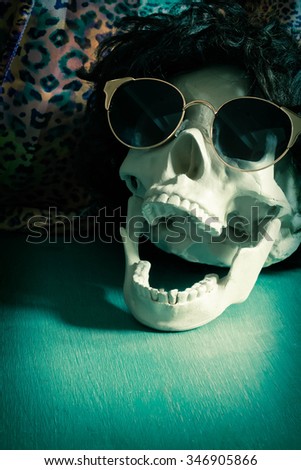 Cool human skull relaxing like a rock star