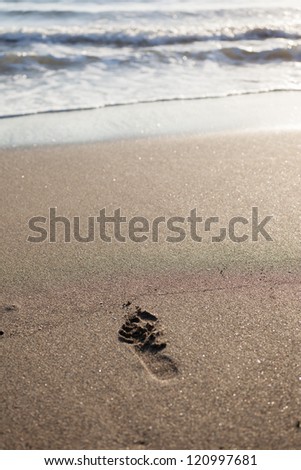foot print on white sand beach and tropical sea
