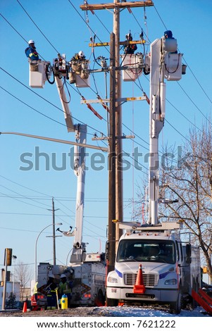 Many Electrical Workers Repairing Power Pole