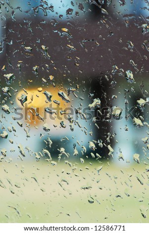 View of Cottage Through Rain-covered Window, Low Depth of Field with Focus on Water Droplets