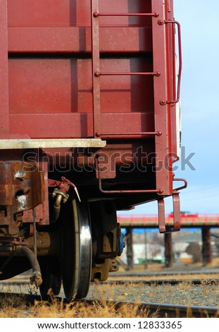 Train Car on the Prairie, Closeup of Wheel with Bridge in background
