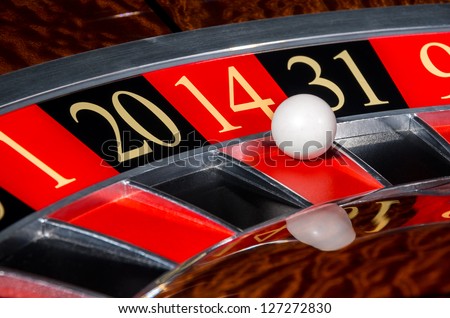 Classic casino roulette wheel with red sector fourteen 14 and white ball