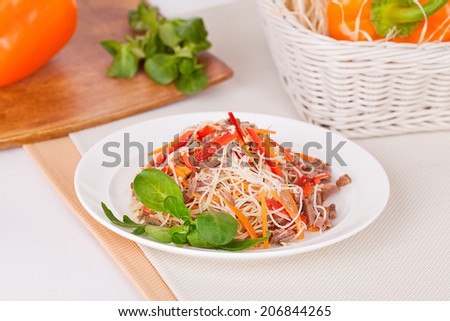 funchoza salad, beef and peppers, corn salad on a plate in a still life