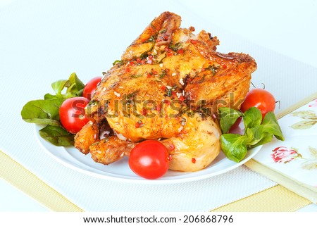 roasted chicken with tomatoes and herbs on a plate