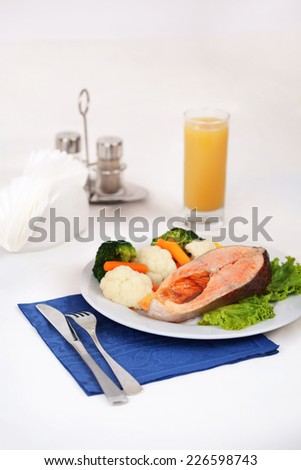 salmon steak with steamed vegetables in still life