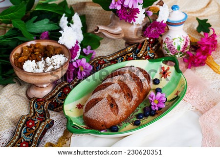 Beautiful Czech nat on loaf in a still life with flowers and ribbons
