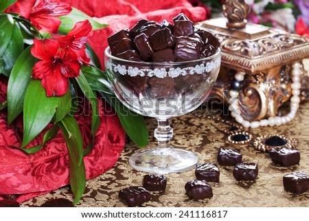 luxury chocolates in a still life with beads and gold casket