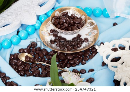 chocolate dragees in a still life in blue colors with fine lines