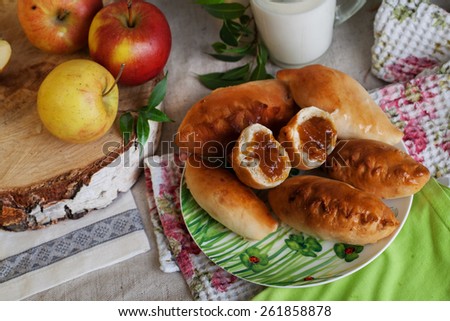 homemade cakes with apple jam in a still life, a mug of milk