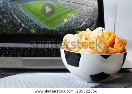 football bowl of chips at a computer with a video broadcast sports fan men, sports, view, home, food
